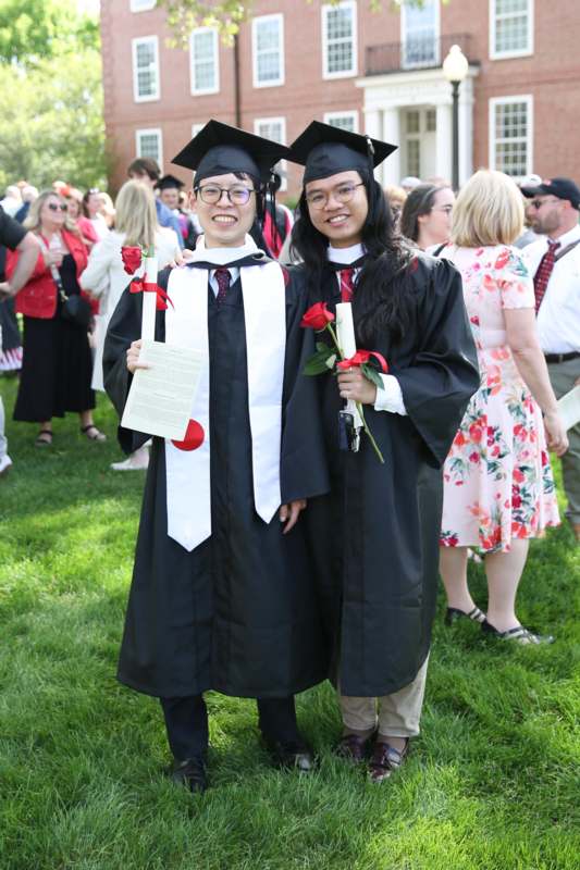 a couple of people in graduation gowns and caps