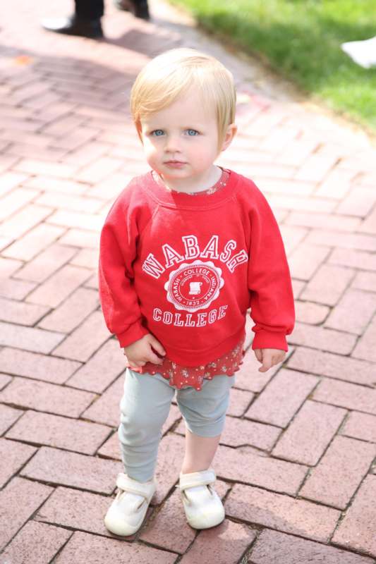 a child standing on a brick path