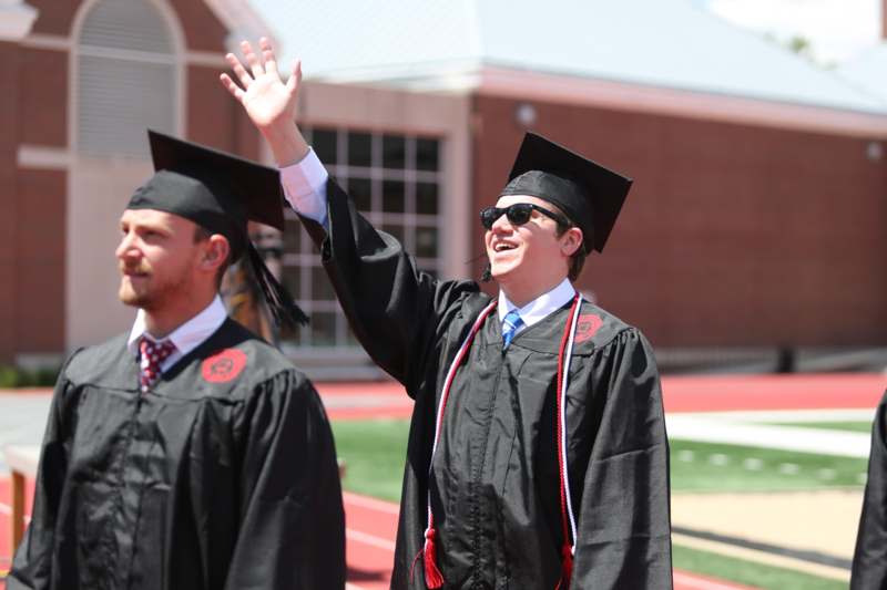 a group of men in graduation gowns and cap and gowns