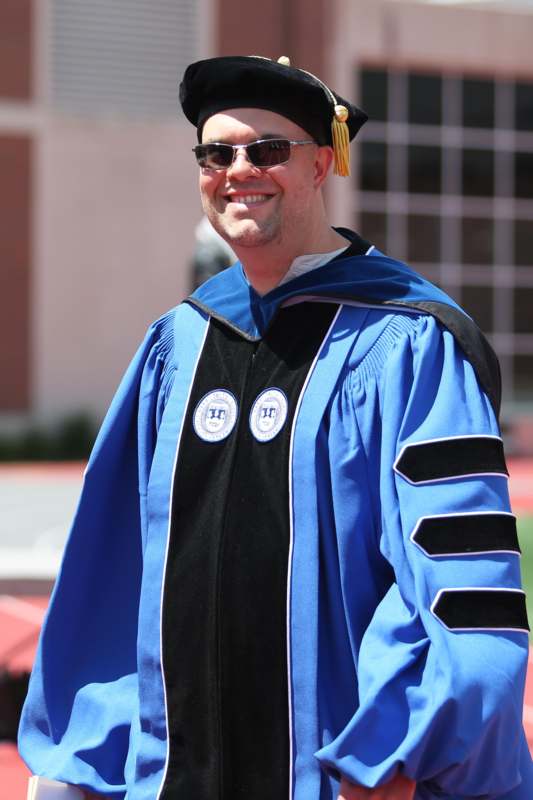 a man wearing a graduation gown and cap