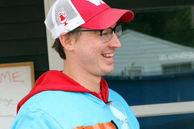 a man wearing a red and white cap and glasses