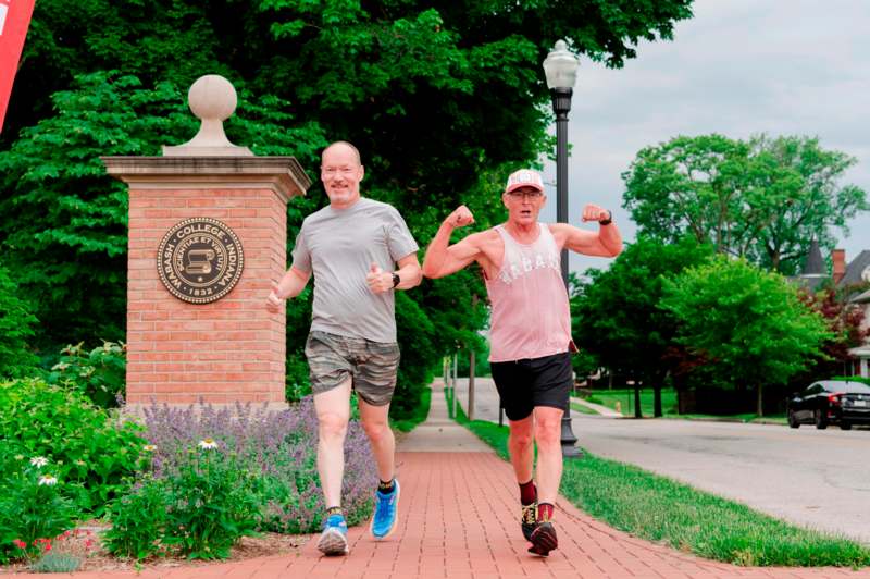 two men running on a brick path
