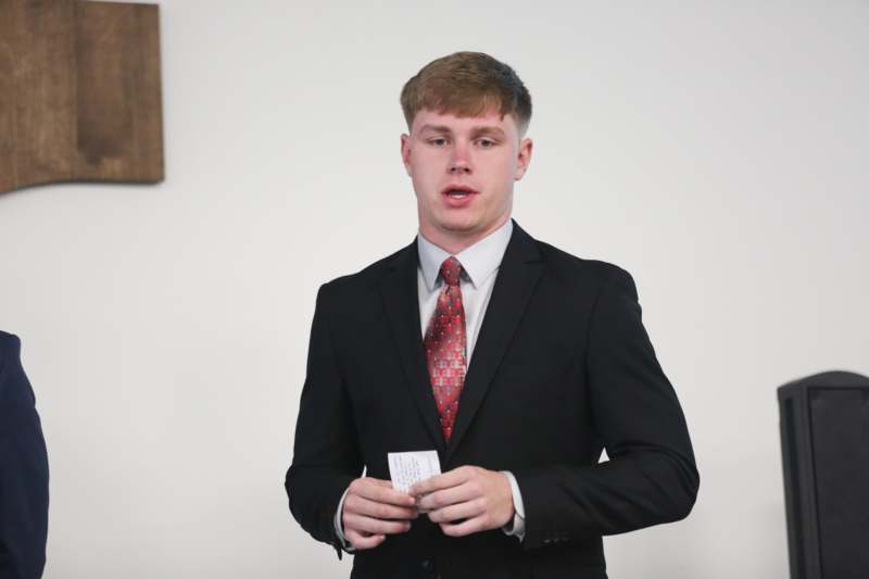 a man in a suit holding a piece of paper