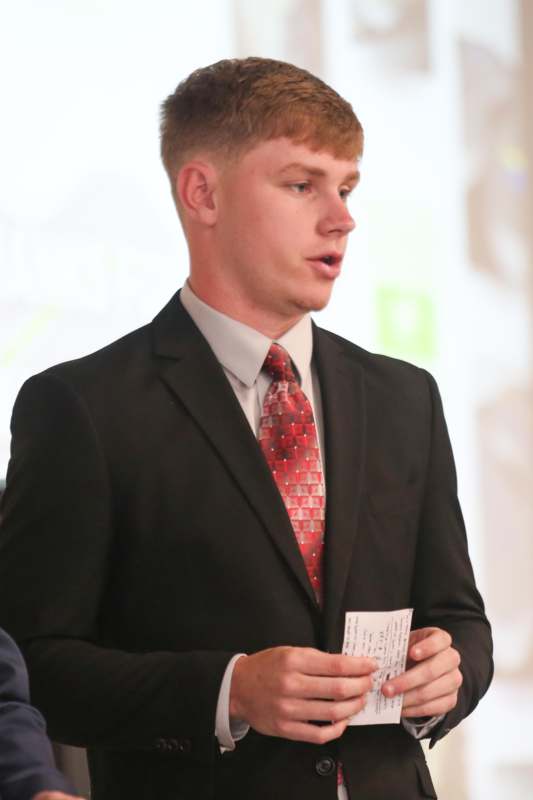 a man in a suit holding a piece of paper