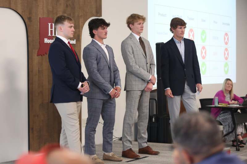 a group of men standing in suits