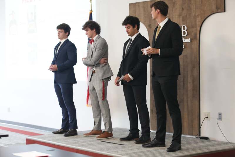 a group of men standing on a stage