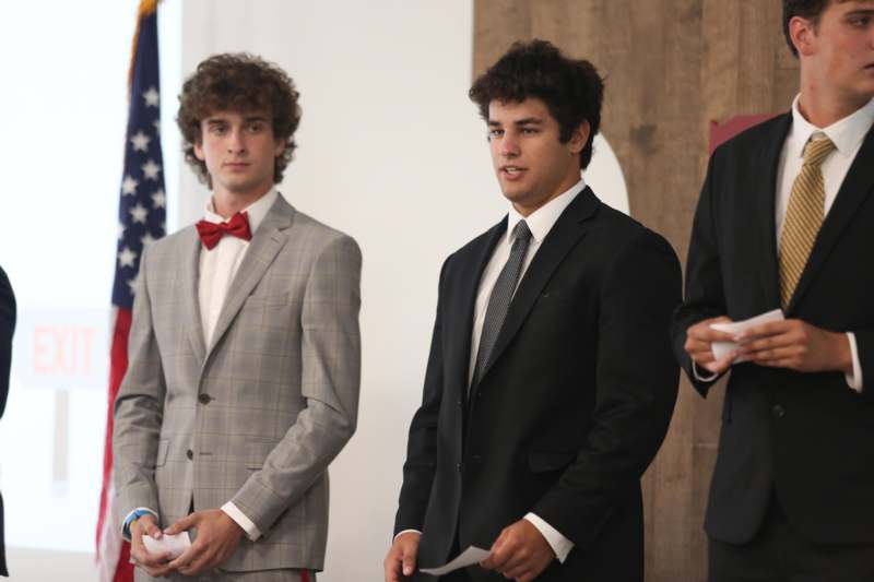 a group of men standing in suits