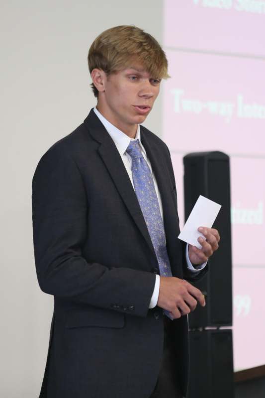 a man in a suit holding a piece of paper