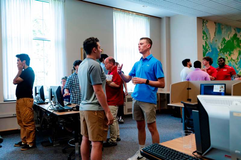 a group of people in a room with computers