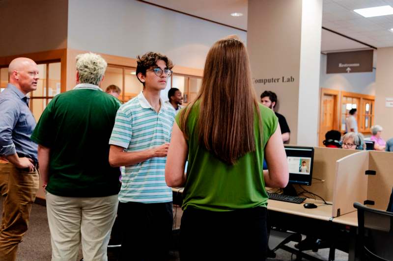 a group of people in a room with computers