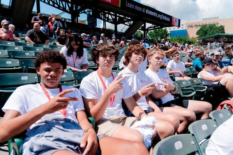 a group of people sitting in chairs in a stadium