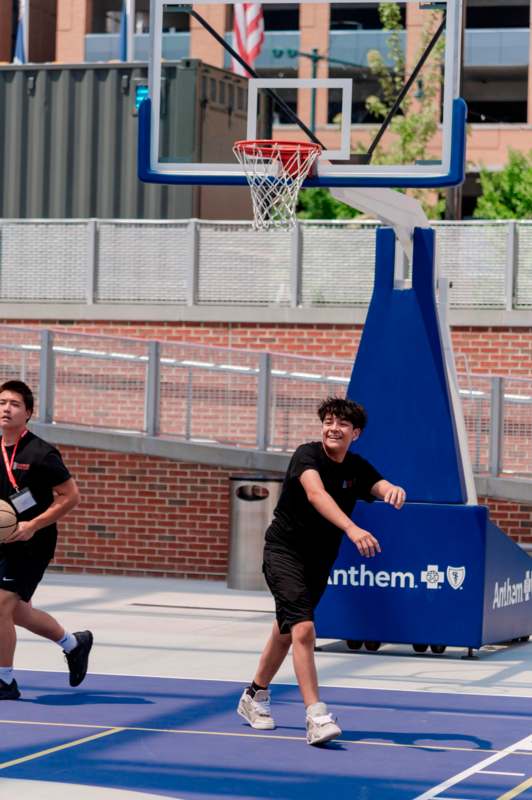 a man playing basketball outside