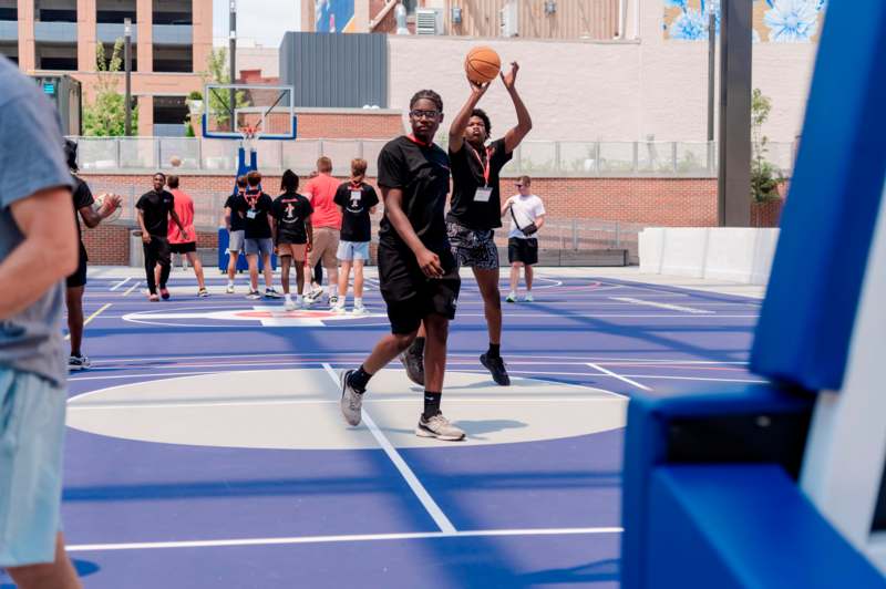 a group of people playing basketball