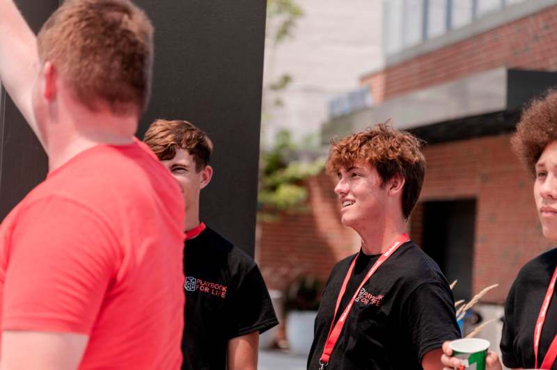 a group of young men standing outside