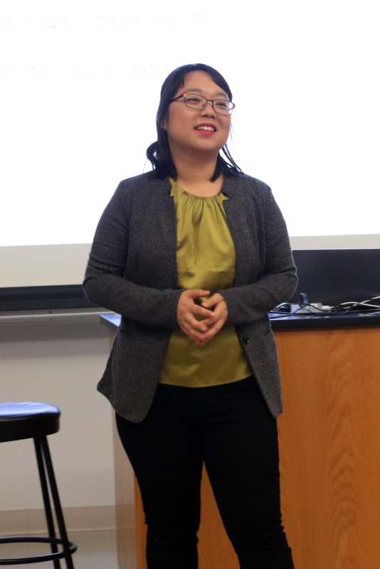 a woman standing in front of a white board