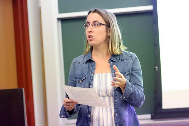 a woman holding a piece of paper