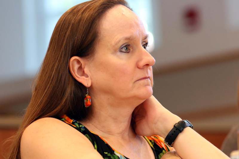 a woman with long hair wearing a watch