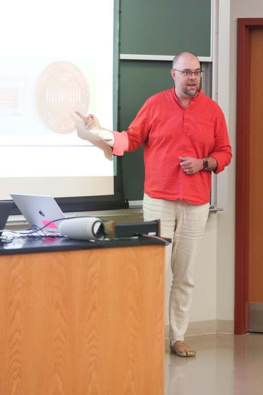 a man standing in front of a screen