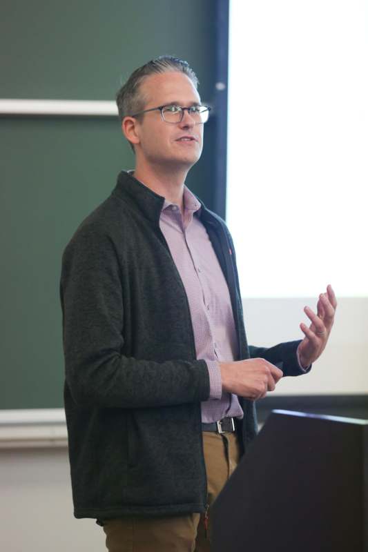 a man standing in front of a chalkboard