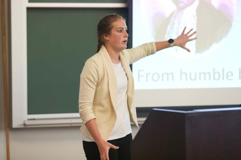 a woman standing in front of a screen