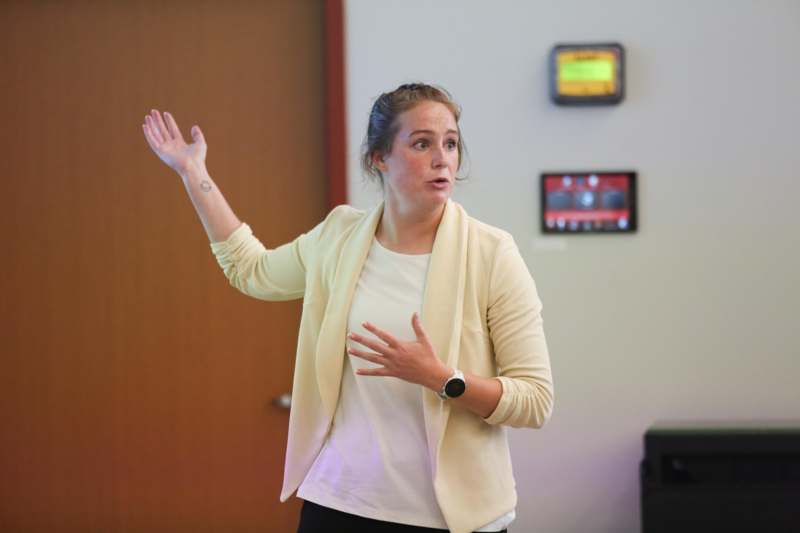 a woman standing in front of a screen