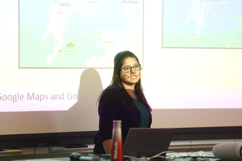 a woman standing in front of a screen