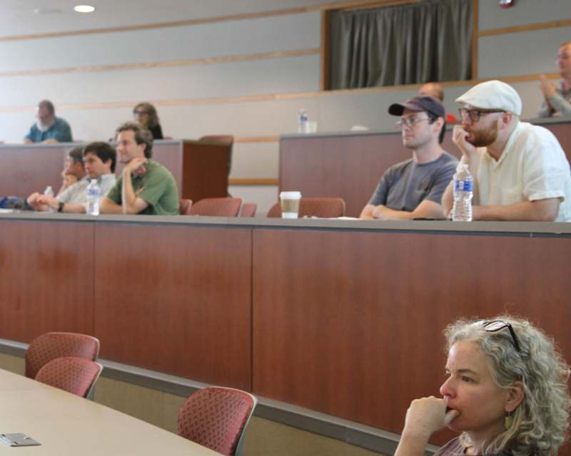 a group of people sitting in a lecture hall