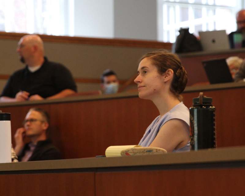 a woman sitting in a lecture hall