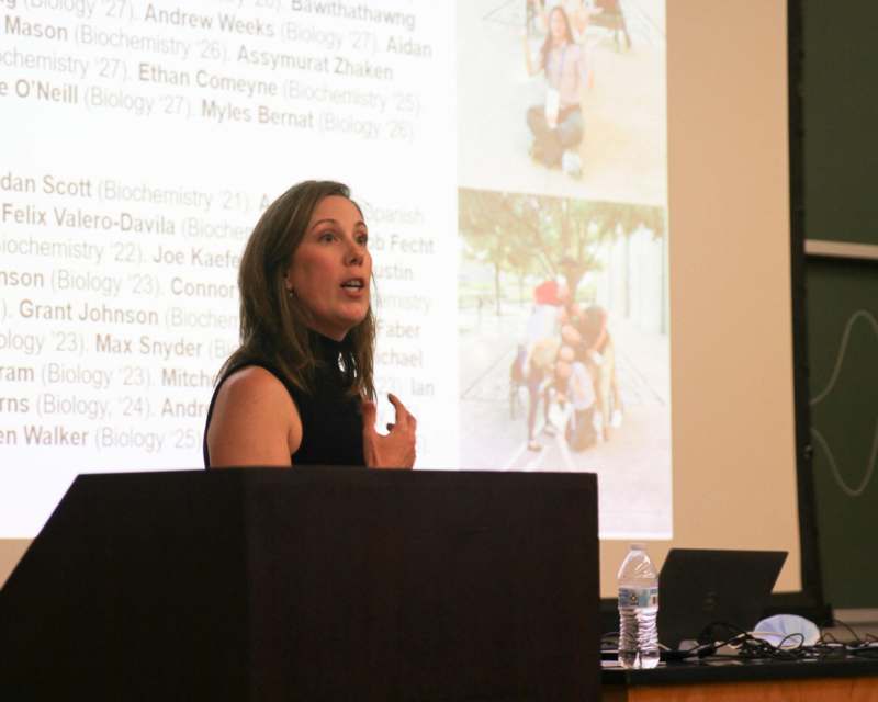 a woman standing in front of a screen