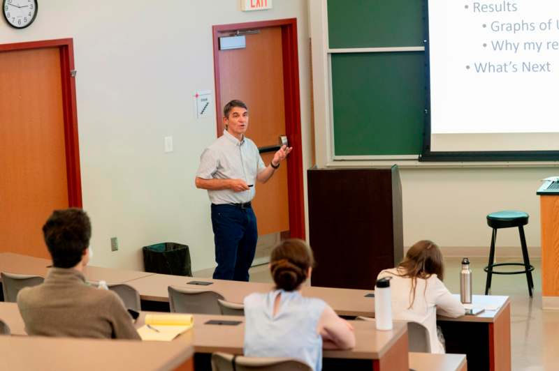 a man standing in front of a classroom