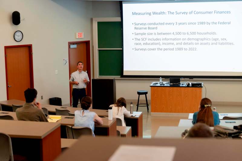 a man standing in front of a screen