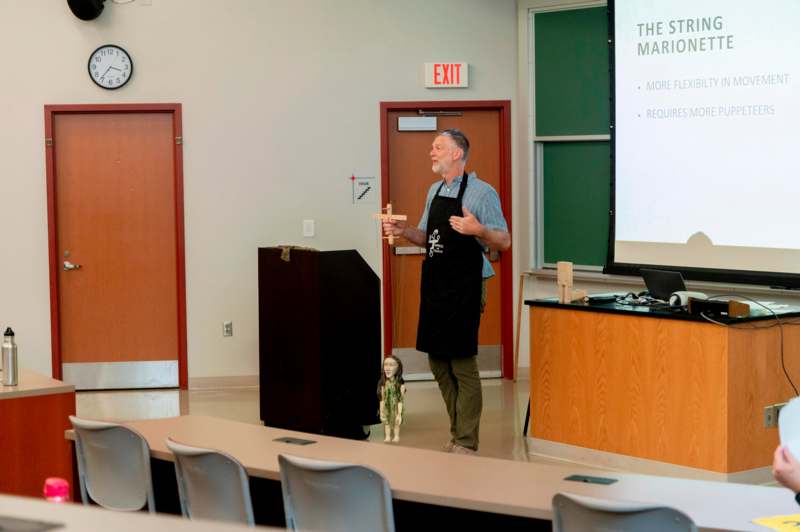 a man in an apron standing in front of a podium