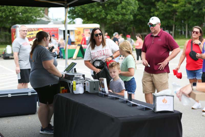 a group of people standing next to a table