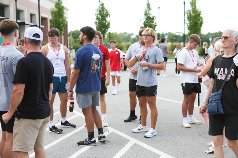 a group of people standing in a parking lot