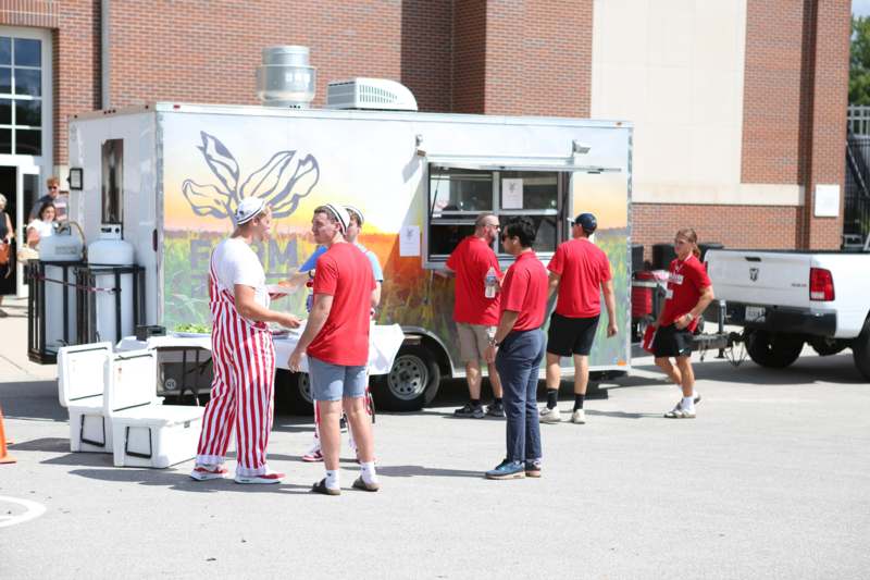 a group of people in red shirts