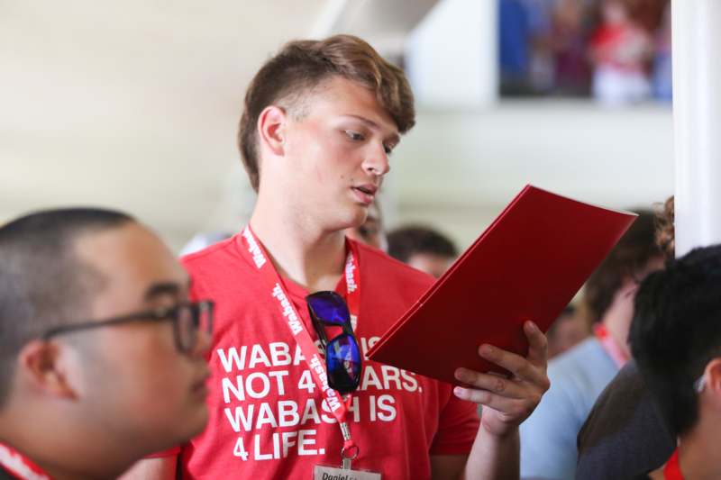 a man holding a red folder