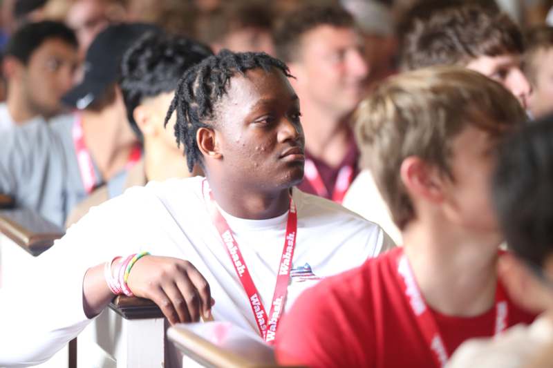 a man sitting in a room with other people