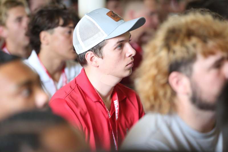 a man wearing a hat and red shirt