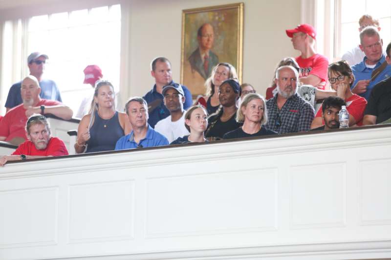 a group of people sitting on a ledge