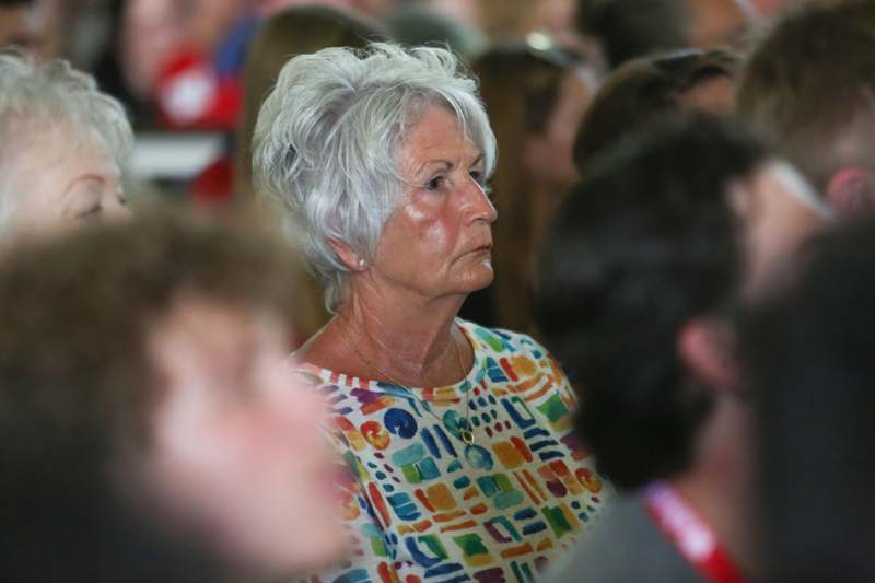 a woman with grey hair and colorful shirt