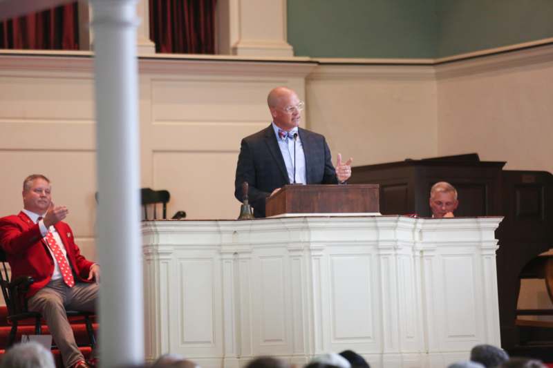 a man giving a speech at a podium