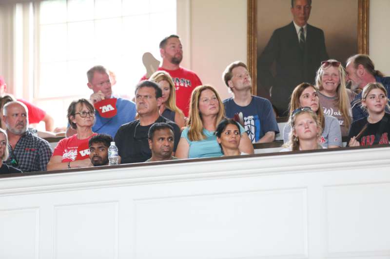 a group of people sitting on a ledge