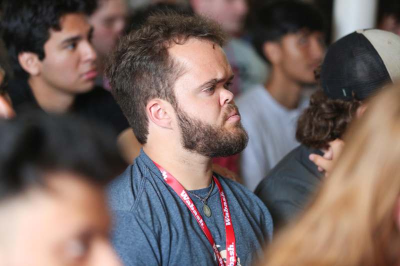 a man with a beard in a crowd