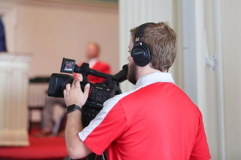 a man with headphones holding a camera