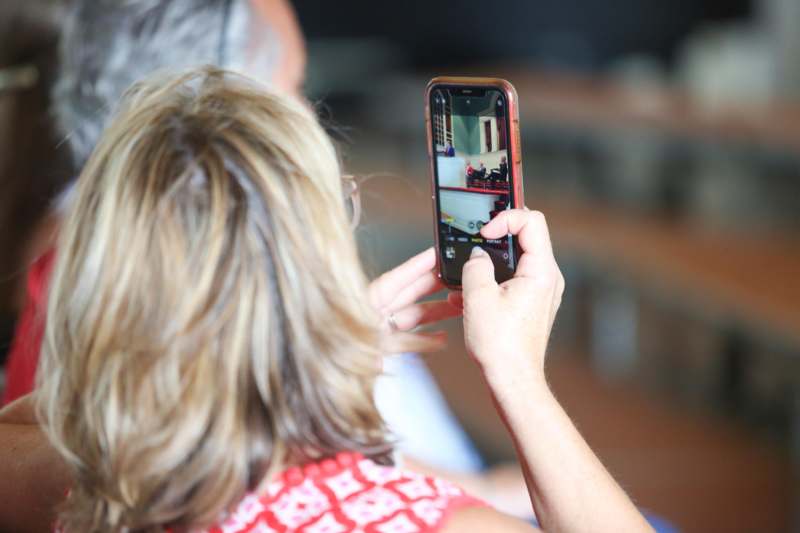 a woman taking a picture of a man