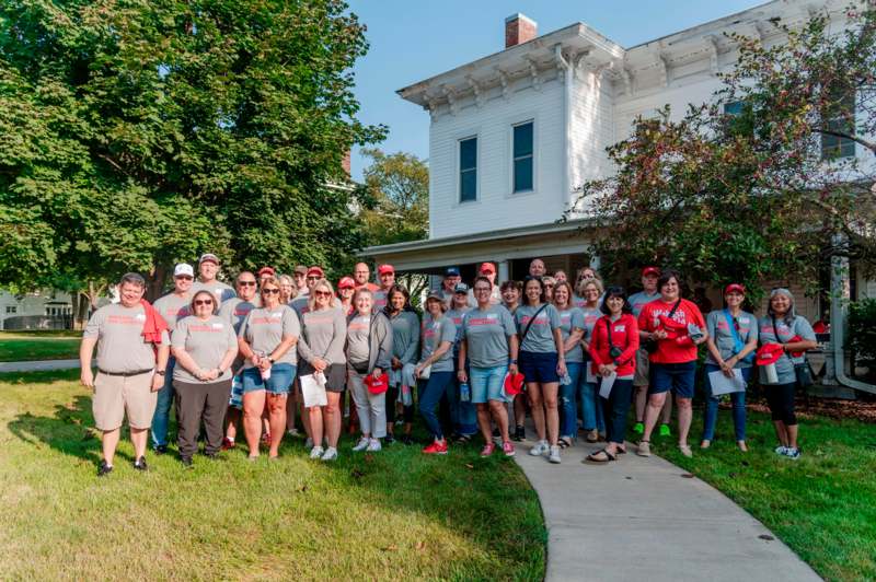 a group of people standing in front of a house