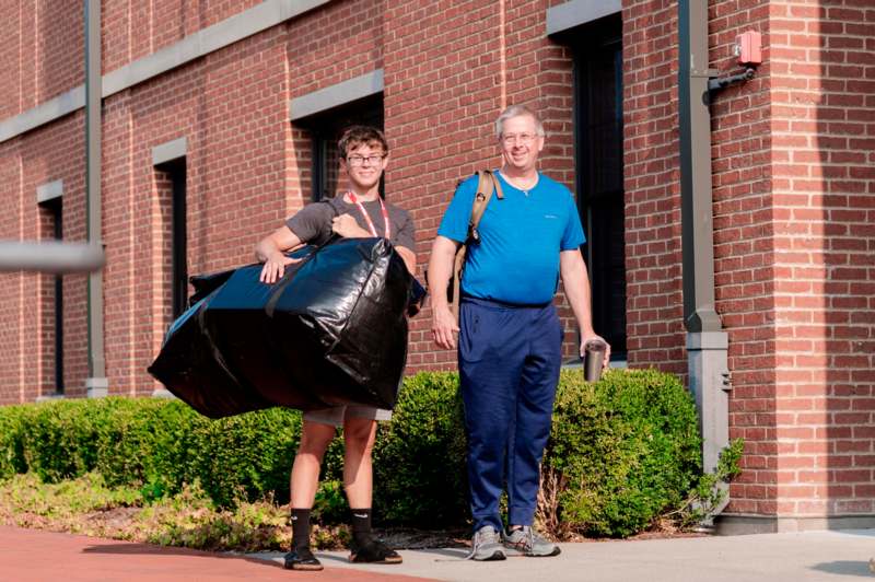 a man holding a bag of trash