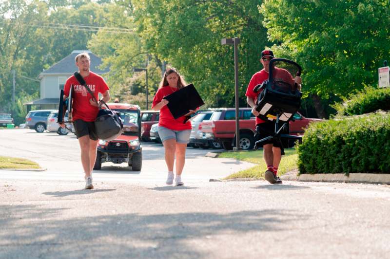 a group of people walking down a street