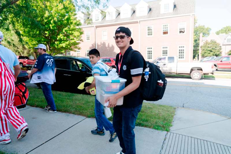 a man carrying a plastic container