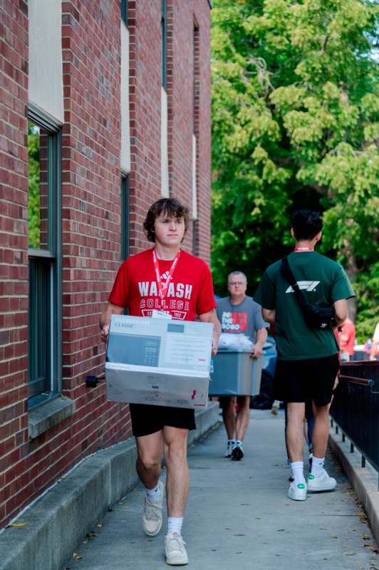 a boy carrying a box